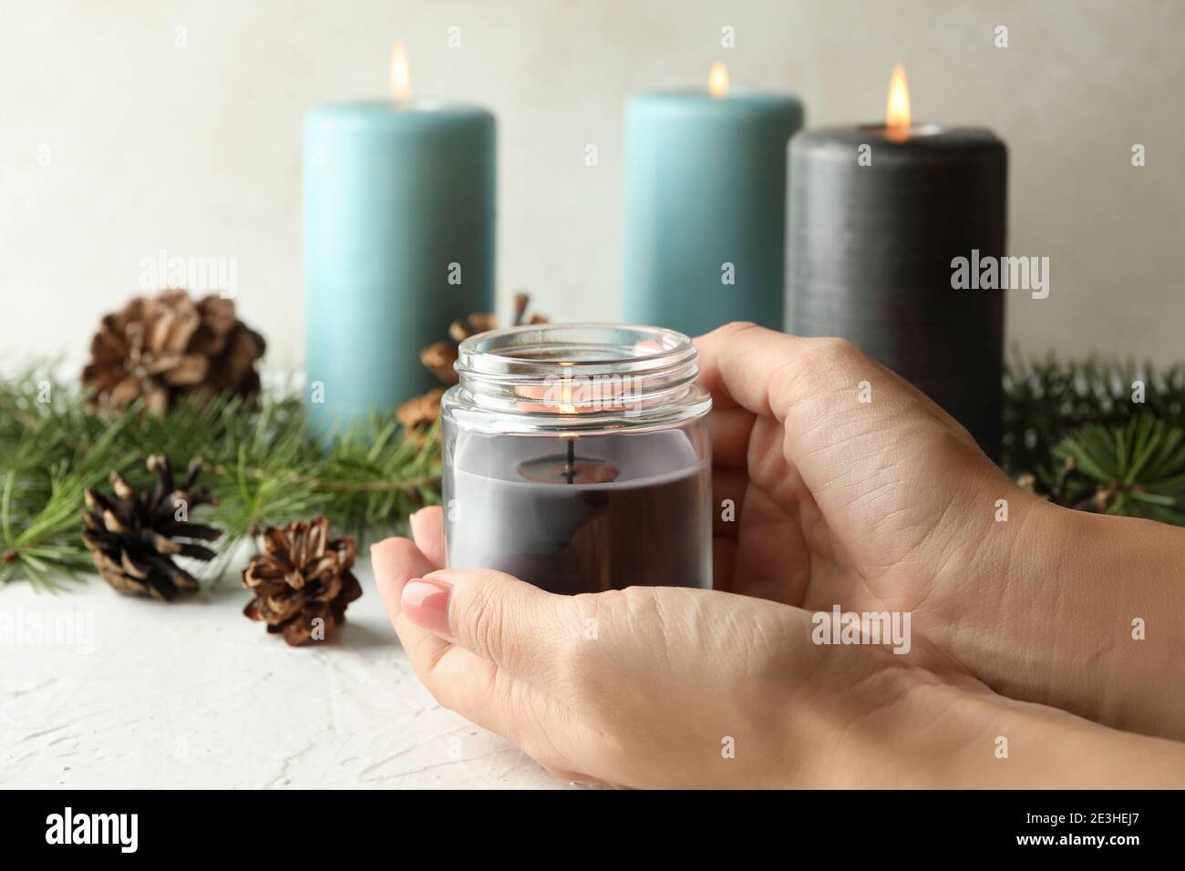Female hands holding burning scented candle in glass jar Stock Photo Alamy