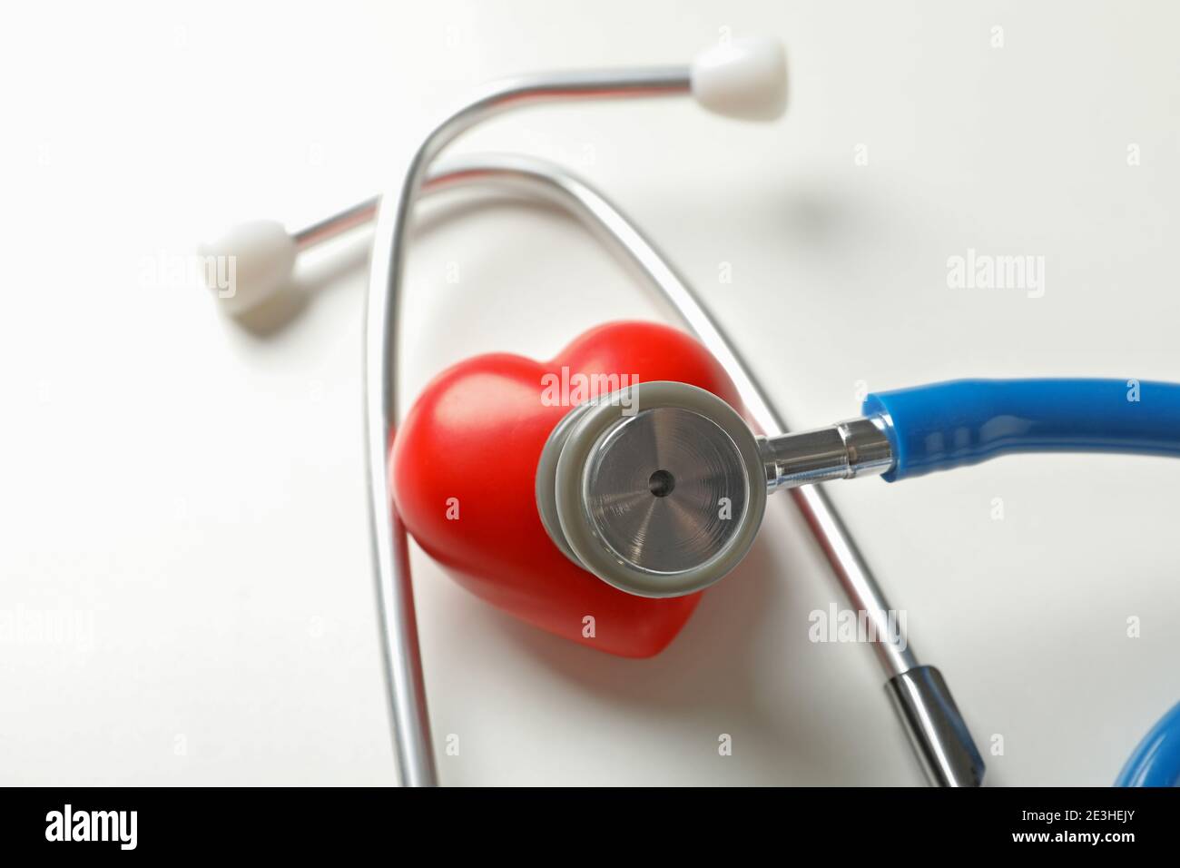 Blue stethoscope and heart on white background Stock Photo - Alamy
