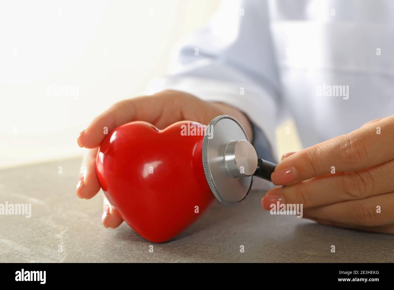 Female doctor with stethoscope checking heart beat Stock Photo - Alamy