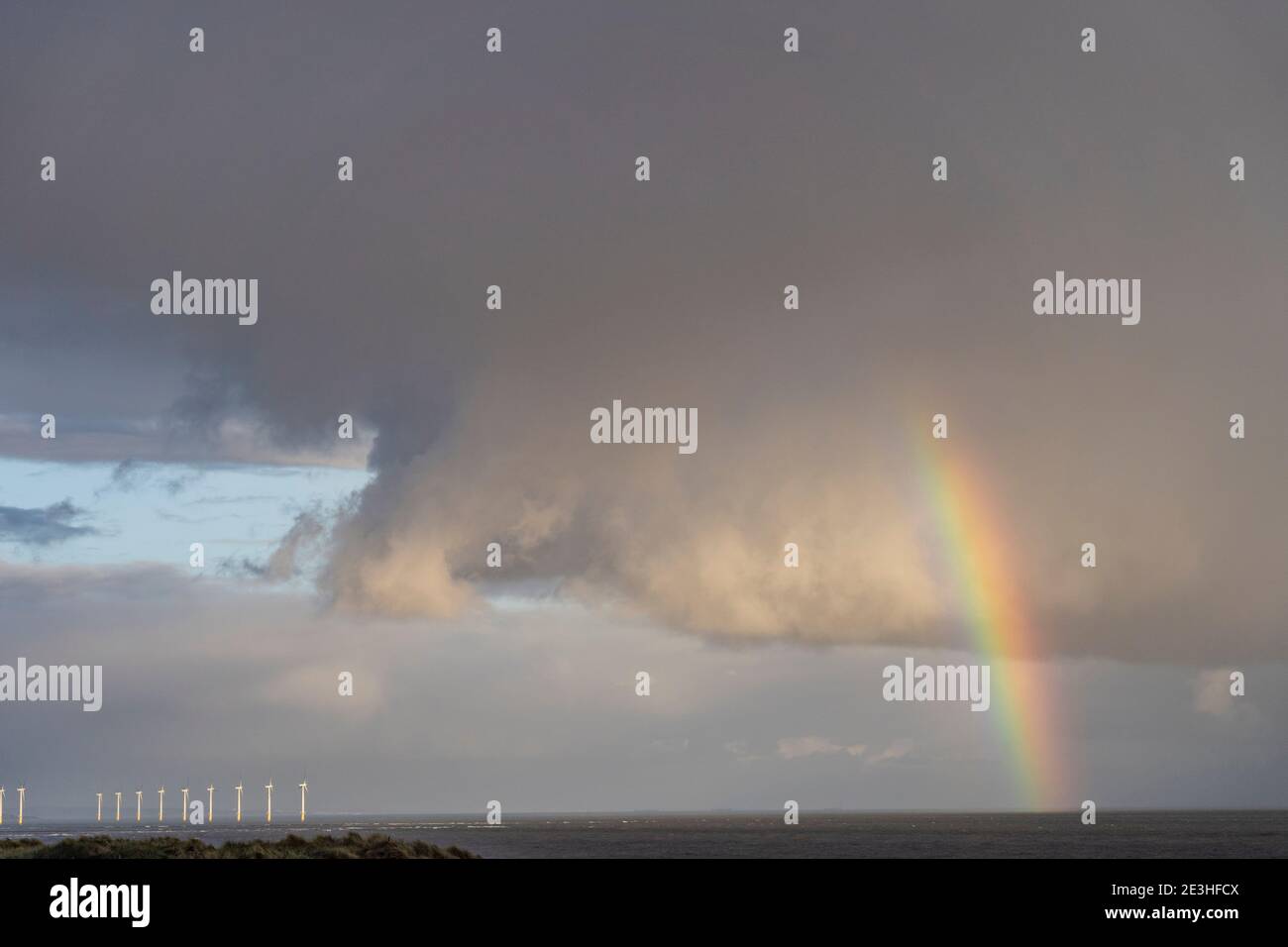 rainbow & clouds over north sea Stock Photo
