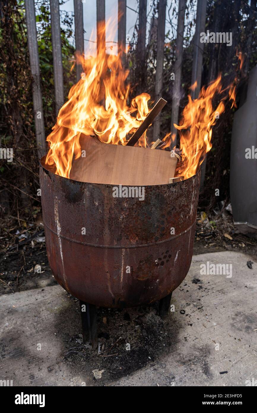 burning rubbish if a fire pit with orange flames Stock Photo Alamy
