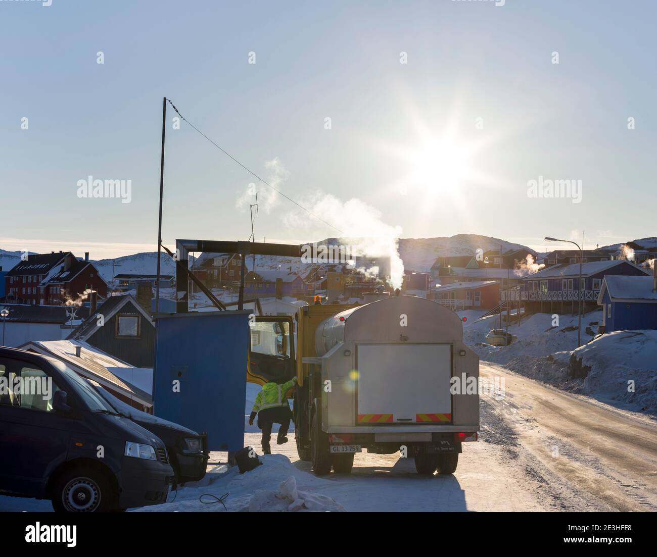 Drinking water is delivered by trucks as not all houses are connected too the water network. Winter in Ilulissat on the shore of Disko Bay. America, N Stock Photo