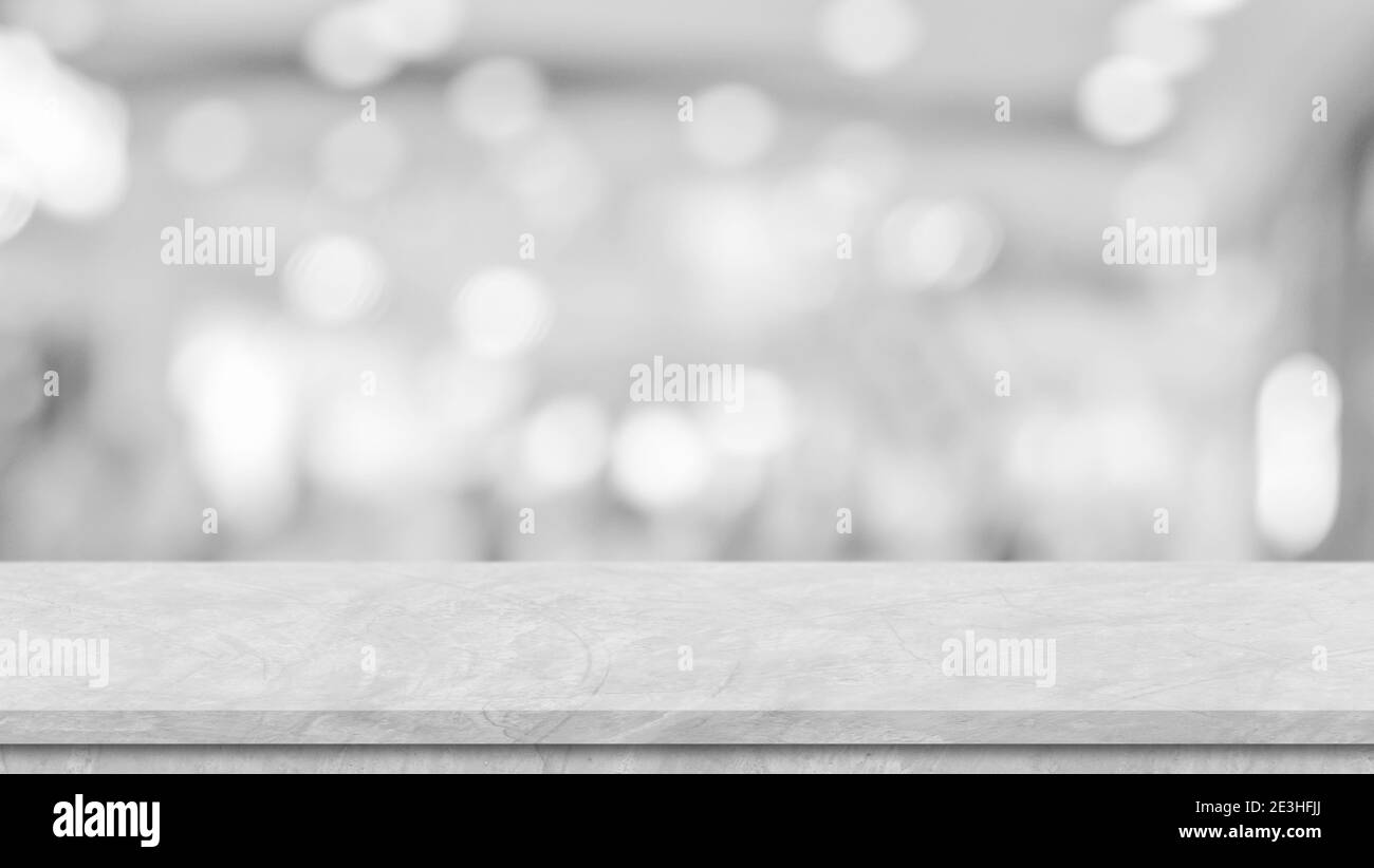 Cement white table top perspective, counter, desk over blur bokeh light background, for product display, mockup, montage, template. Stock Photo