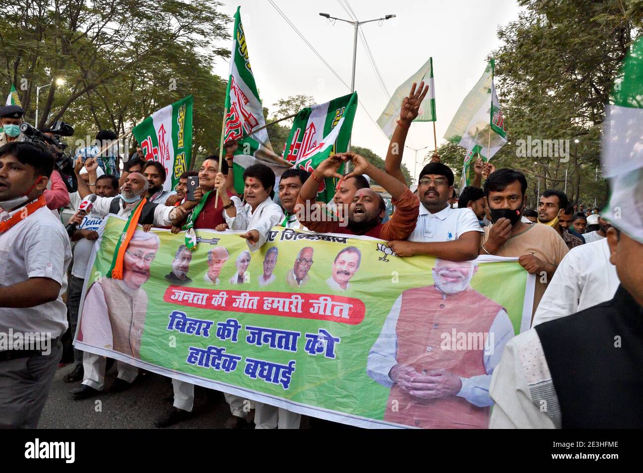 Party workers celebrating their victory in the state elections by taking out a rally. Stock Photo