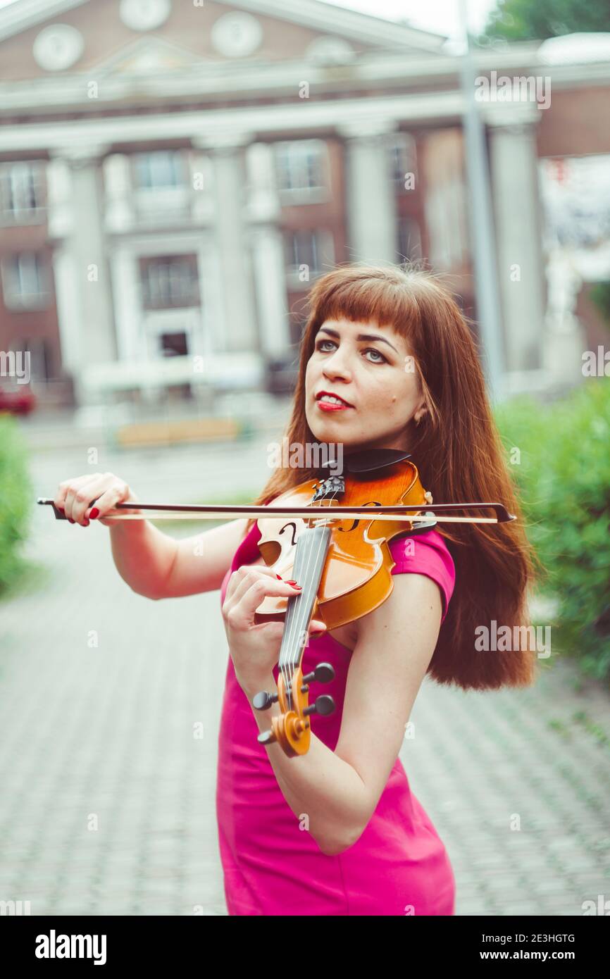 beautiful girl playing violin in white dress in forest Stock Photo - Alamy