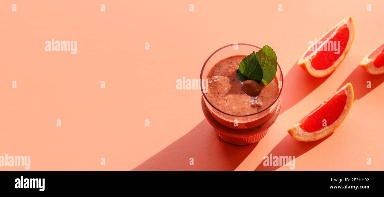 Banner with a healthy, grapefruit super food smoothie isolated on coloured background Stock Photo