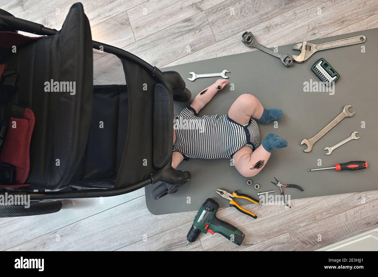 Mechanic Little Boy Repairing Suspension Of A Baby Stroller Stock Photo Alamy