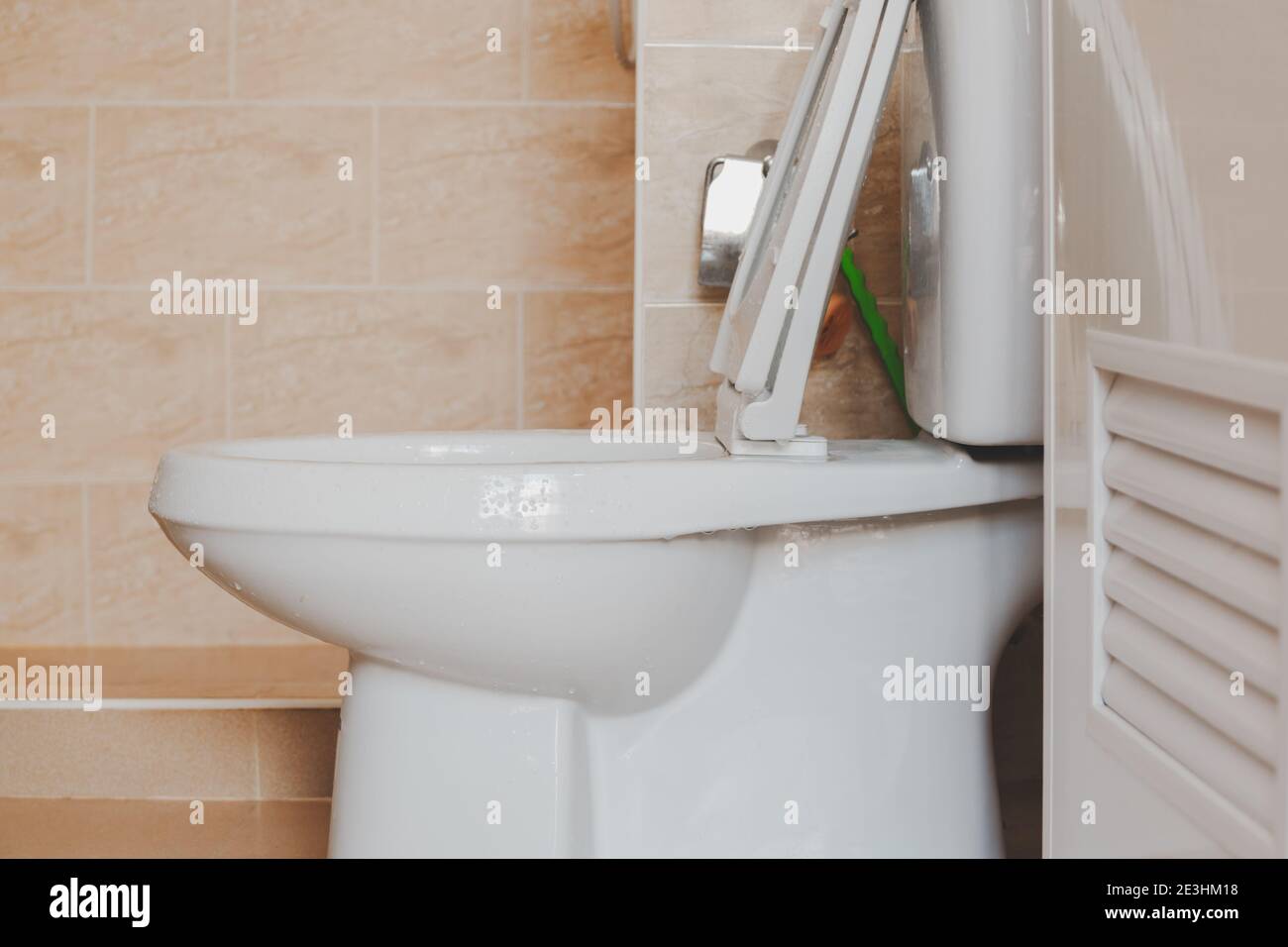 Close up the flush toilet made of ceramic in the bathroom. Stock Photo