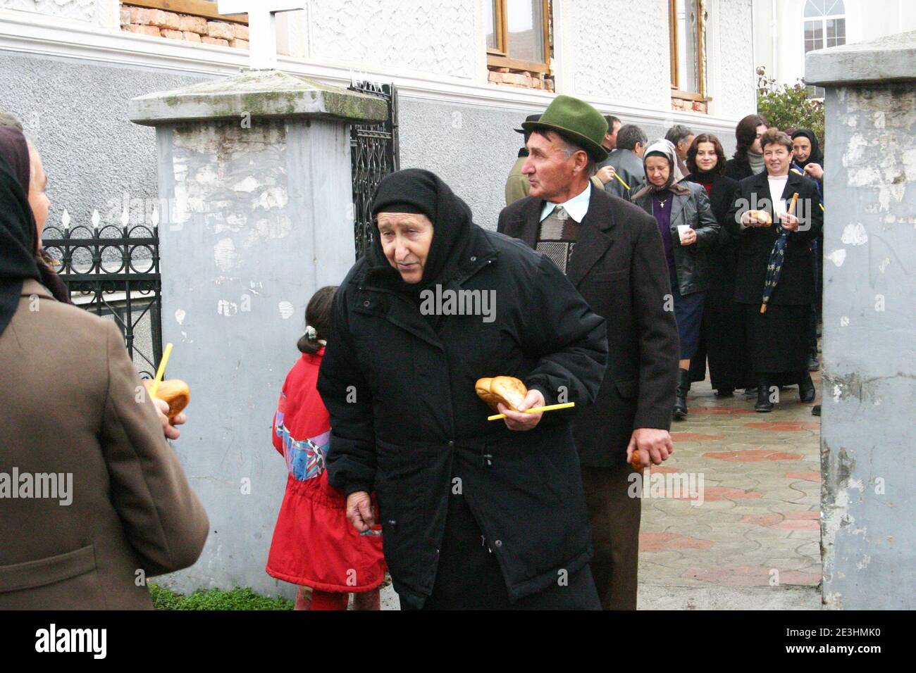Brasov County, Romania. Villagers coming out of the church with alms in their hands. Stock Photo