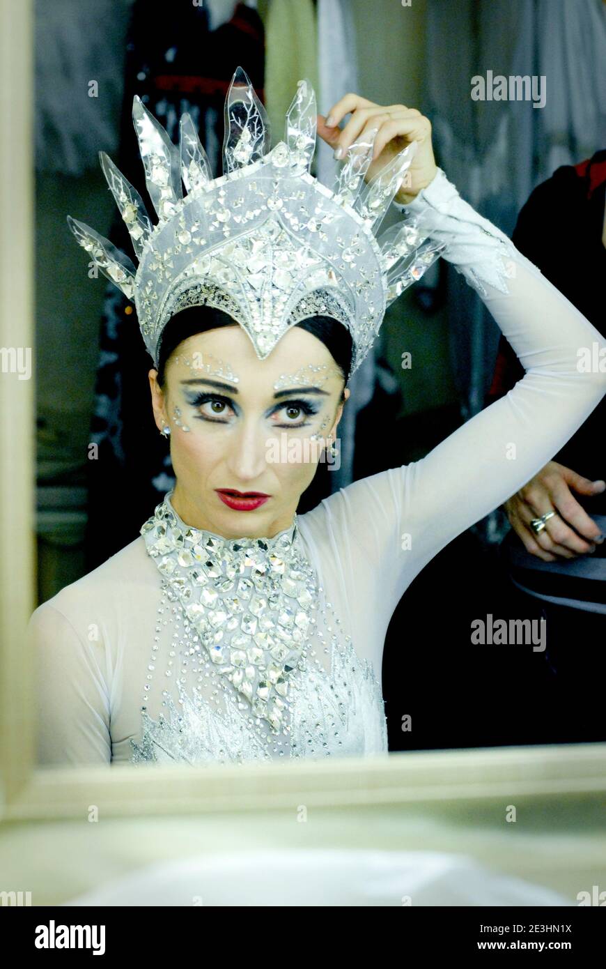 Snow Queen Ballerina looks in mirror Stock Photo