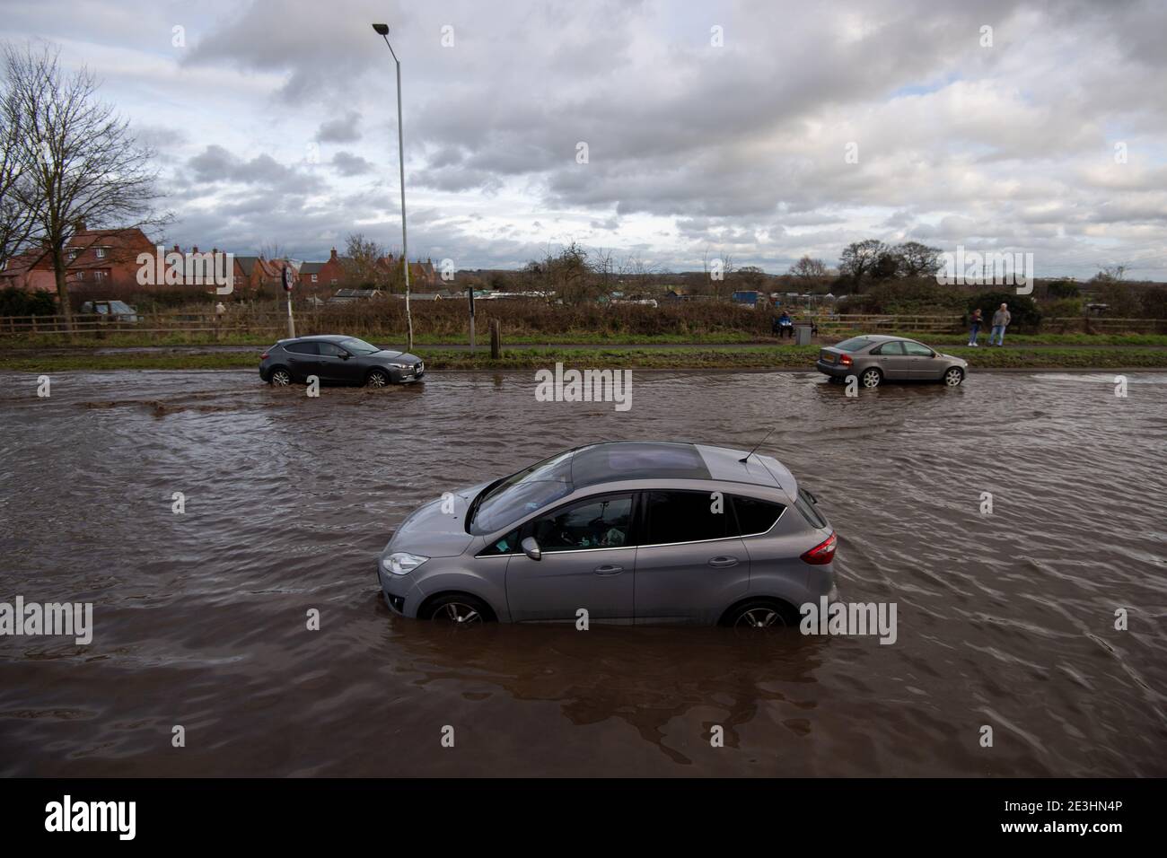Stranded cars in floodwater on Derby Road in Hathern, Leicestershire. Picture date: Tuesday January 19, 2021. Stock Photo