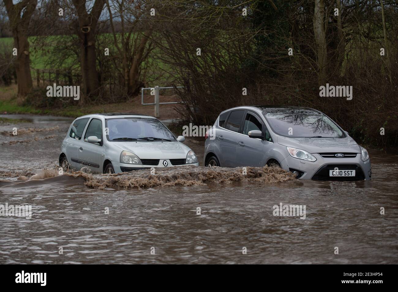 Motorists make their way through floodwater on Derby Road in Hathern, Leicestershire. Picture date: Tuesday January 19, 2021. Stock Photo