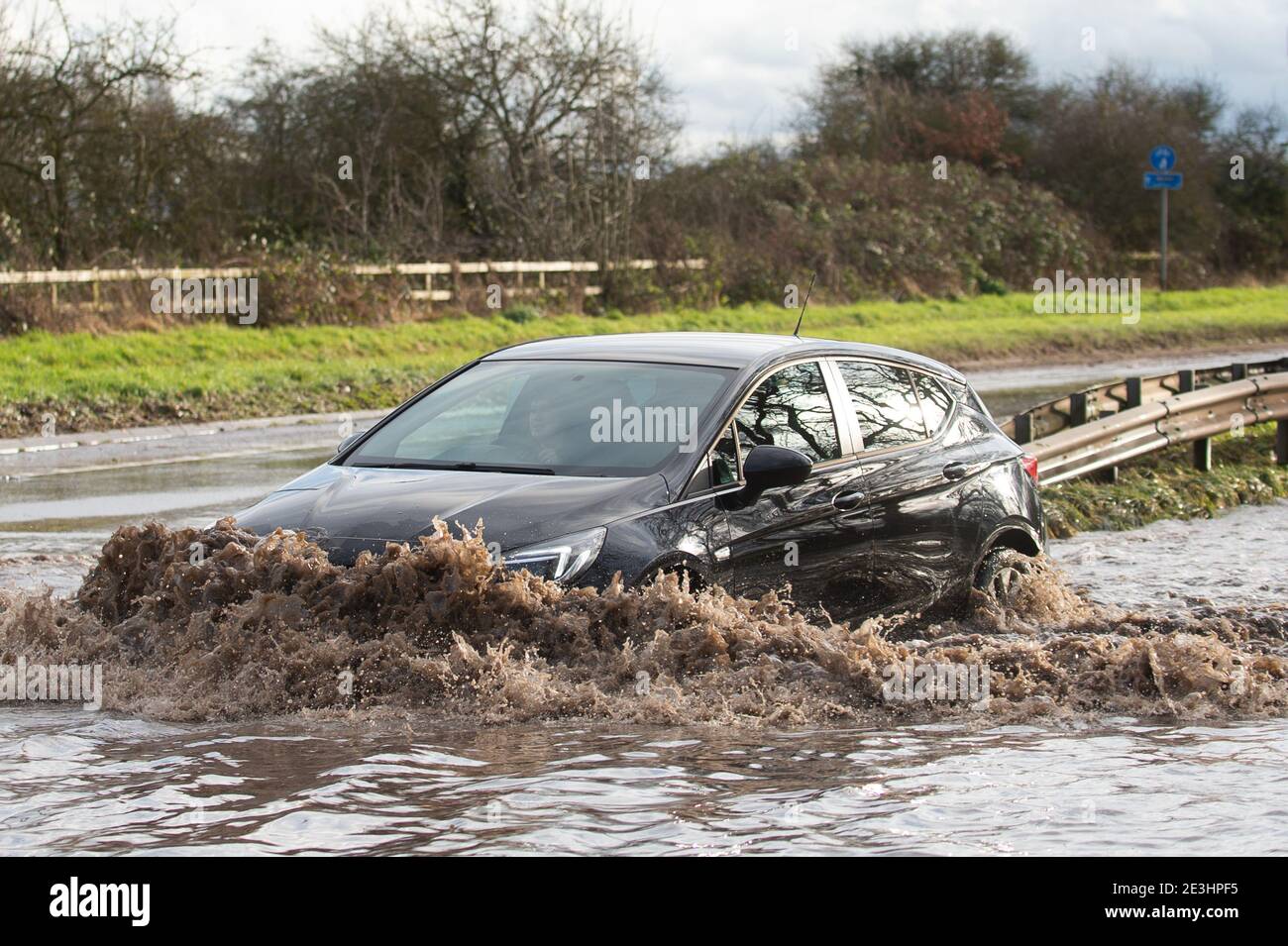 Motorists make their way through floodwater on Derby Road in Hathern, Leicestershire. Picture date: Tuesday January 19, 2021. Stock Photo