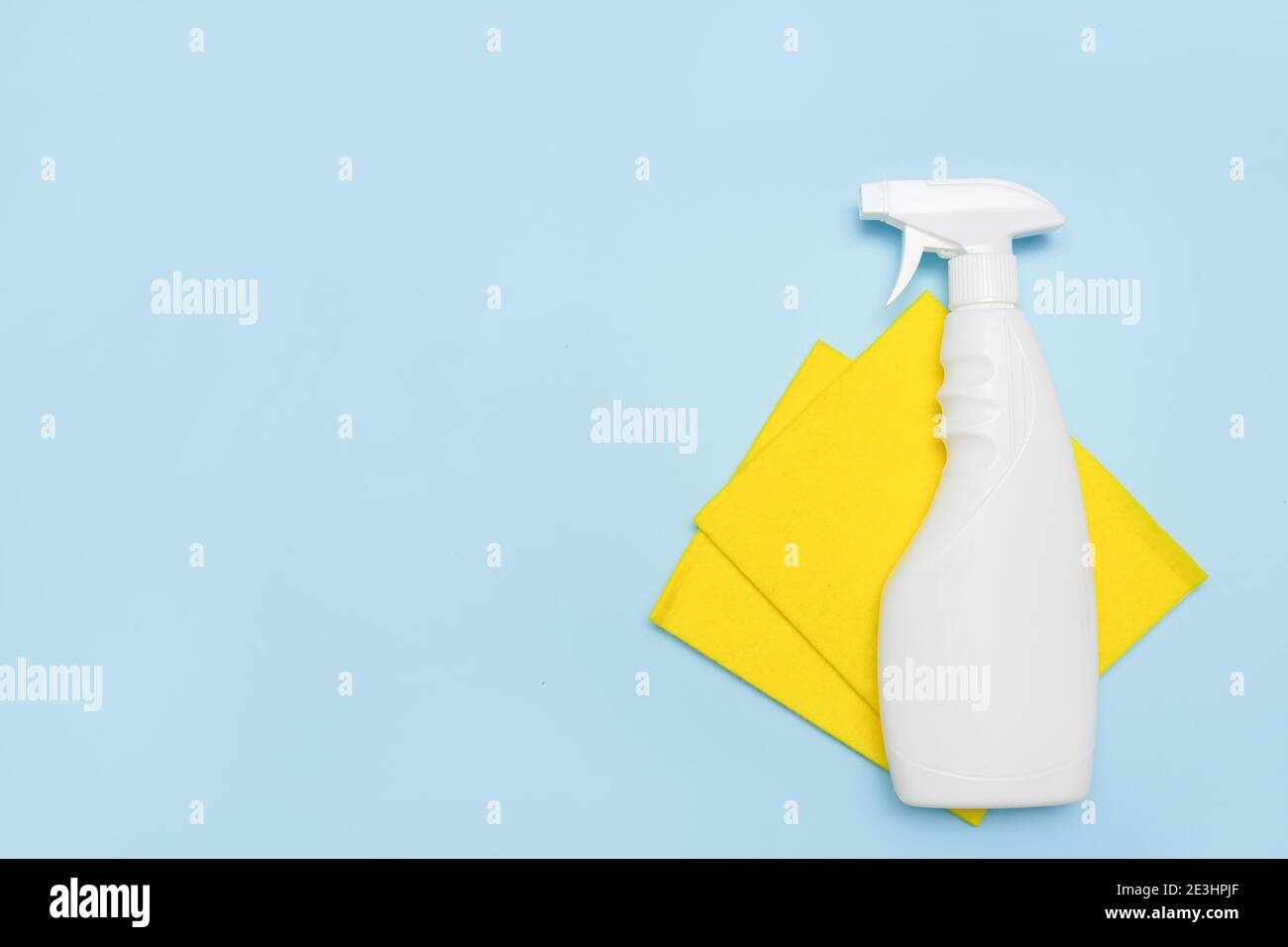 cleaning tools. Empty place for text or logo on blue background. Cleaning service concept. Early spring regular clean up. Top view. Stock Photo