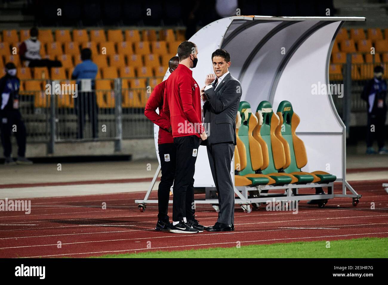 Douala, Cameroon. 18 Jan 2021. Johnathan McKinstry (Head Coach, Uganda)  speaks with technical staff Abdallah Mubiru (Assistant Coach, Uganda) and  Alex McCarthy (Performance Analyst, Uganda) following the final whistle.  Uganda v Rwanda,