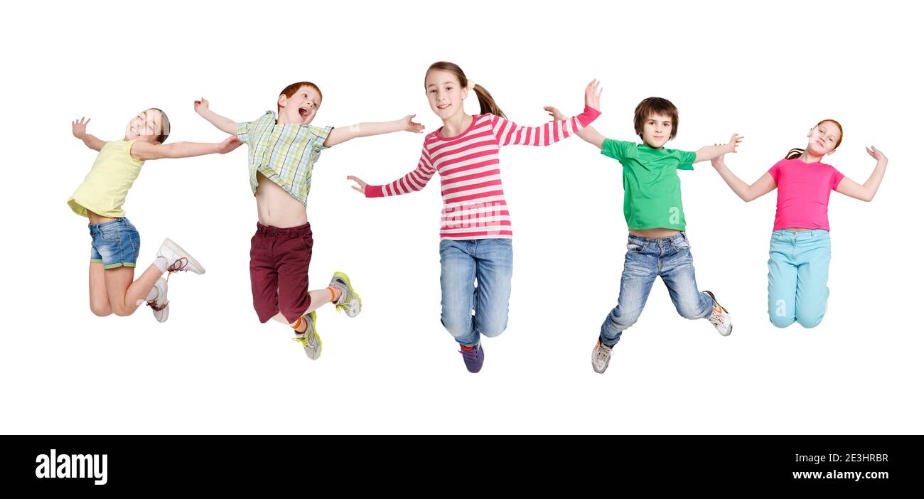 Joyful Children Jumping In Mid-Air Posing Over White Background Stock Photo