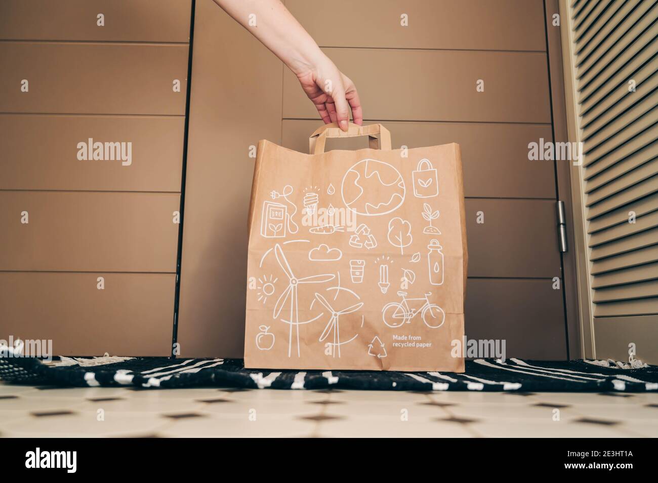 Safe delivery concept. Hand holding bag with ordered products. Organic