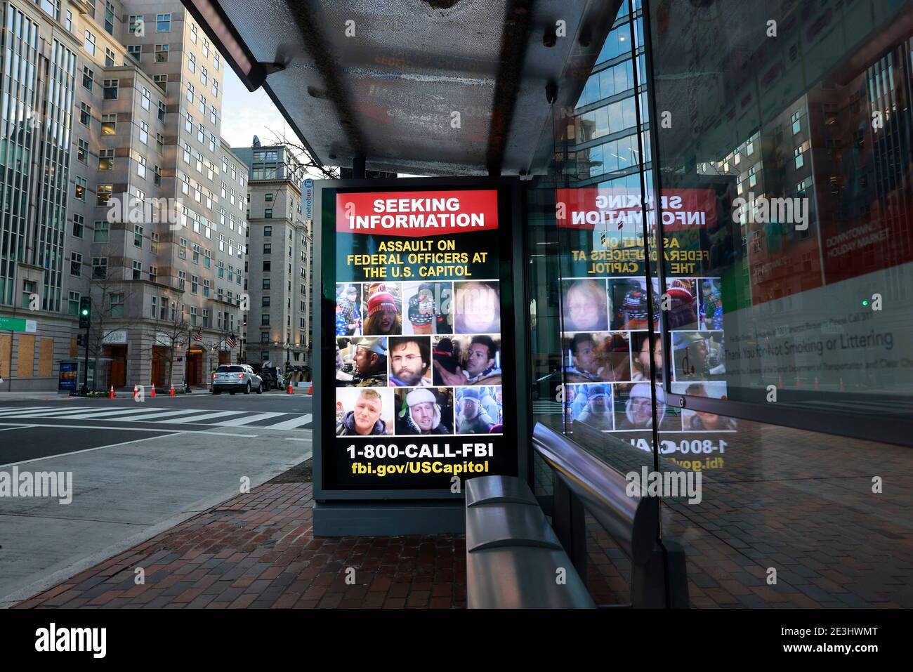 01182021- Washington, District of Columbia, USA: An electronic advertisement not far from the White House snows the faces of suspects who assaulted federal officers at the Capitol Building during the January 6, 2021 storming. The FBI is asking anybody with information about the whereabouts of the suspects to make contact with law enforcement. Stock Photo