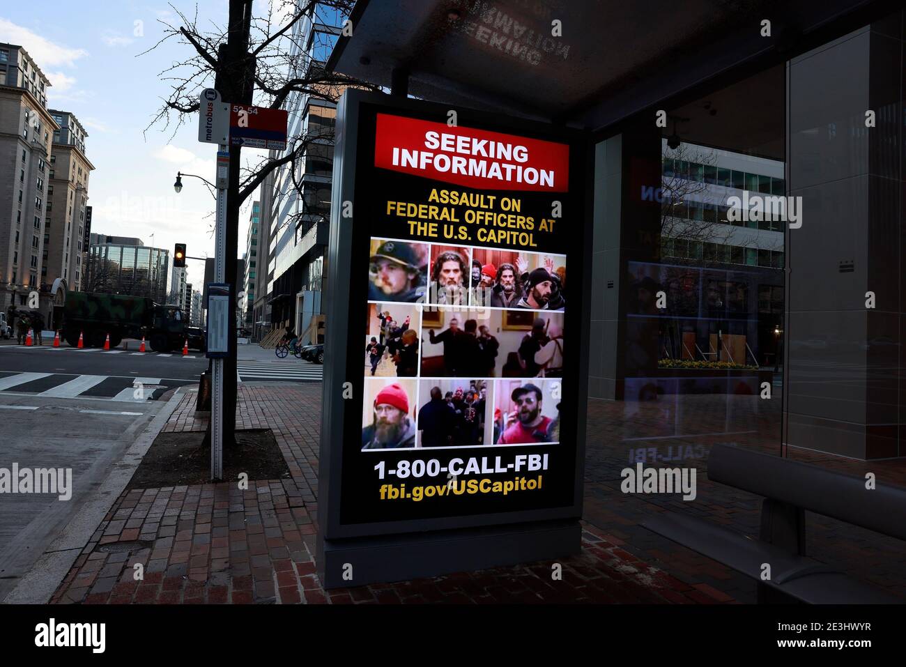 01182021- Washington, District of Columbia, USA: An electronic advertisement not far from the White House snows the faces of suspects who assaulted federal officers at the Capitol Building during the January 6, 2021 storming. The FBI is asking anybody with information about the whereabouts of the suspects to make contact with law enforcement. Stock Photo