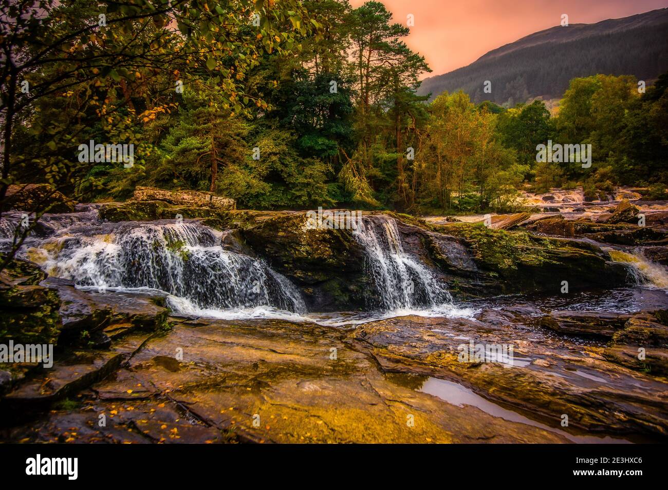The Falls of Dochart are situated on the River Dochart at Killin in Stirling, Scotland at the western end of Loch Tay. A bridge crossing the river as Stock Photo