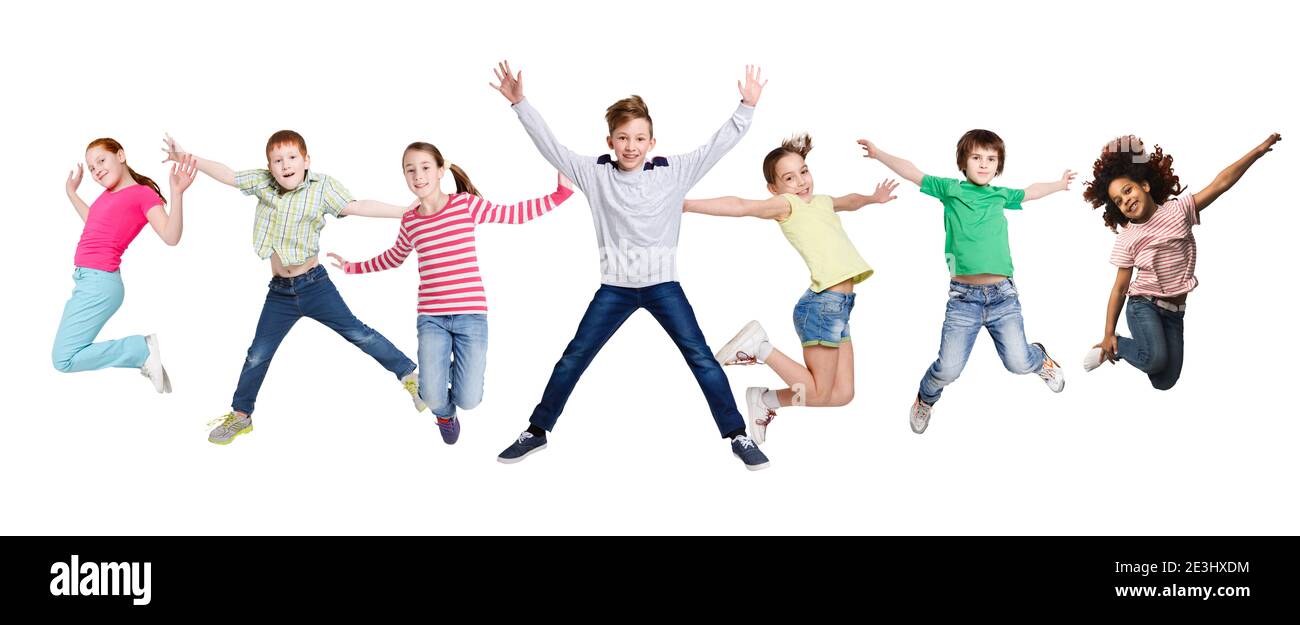 Joyful Multiracial Kids Jumping In Mid-Air Posing Over White Background Stock Photo
