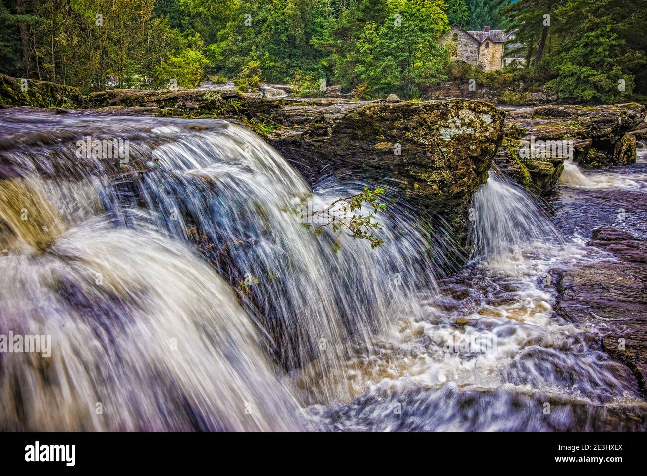 The Falls of Dochart are situated on the River Dochart at Killin in Stirling, Scotland at the western end of Loch Tay. A bridge crossing the river as Stock Photo