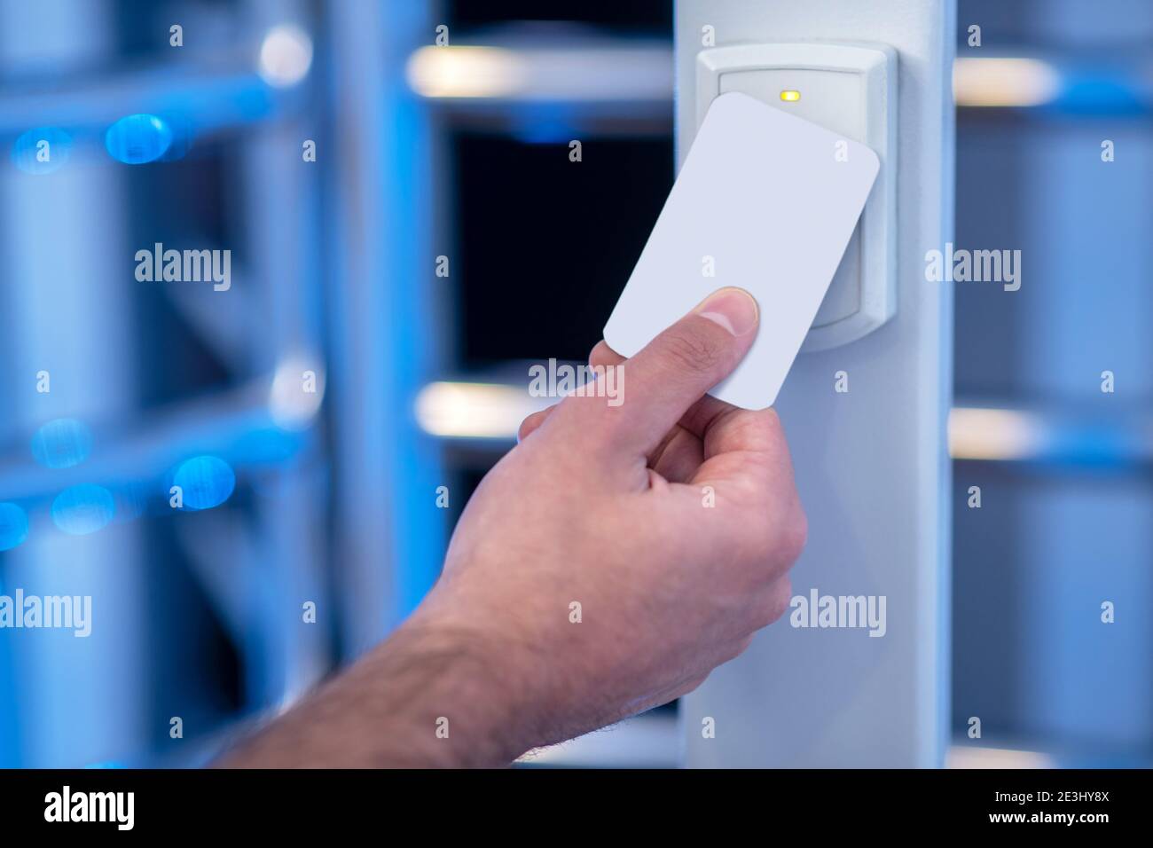 Male hand applying electronic badge to scanning device Stock Photo Alamy