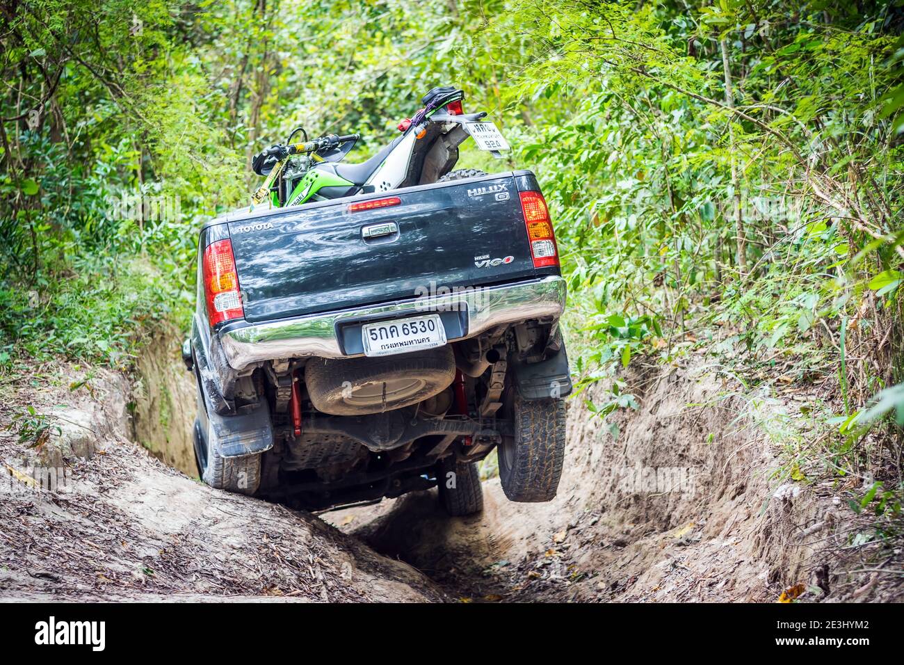 4 wheel drive with a motorcycle on the tailgate is climbing on a