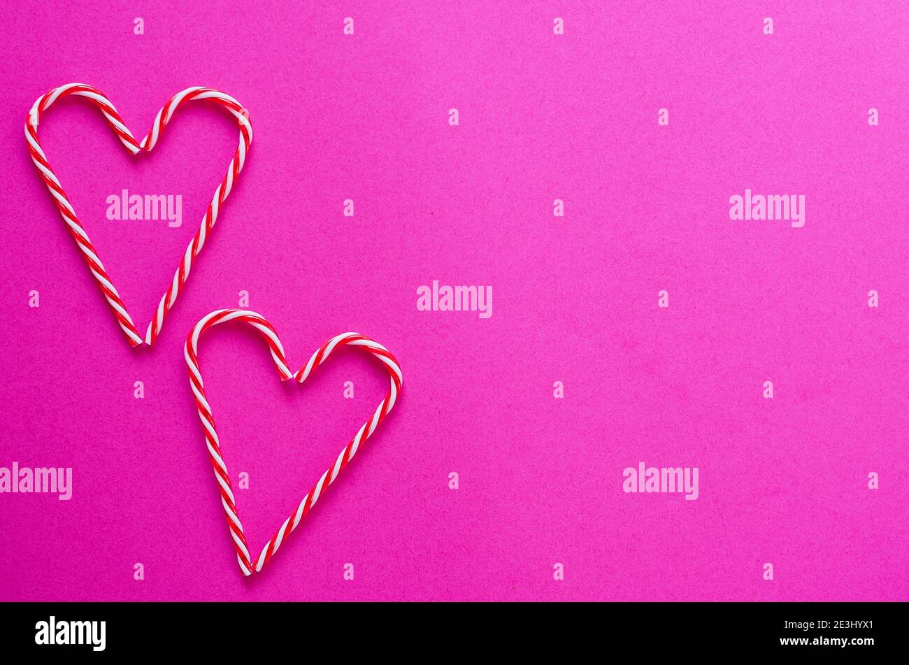 Festive pink background. Hearts of sweet candies. Love. Valentine's Day. 14 of February. Flat lay, top view. Stock Photo