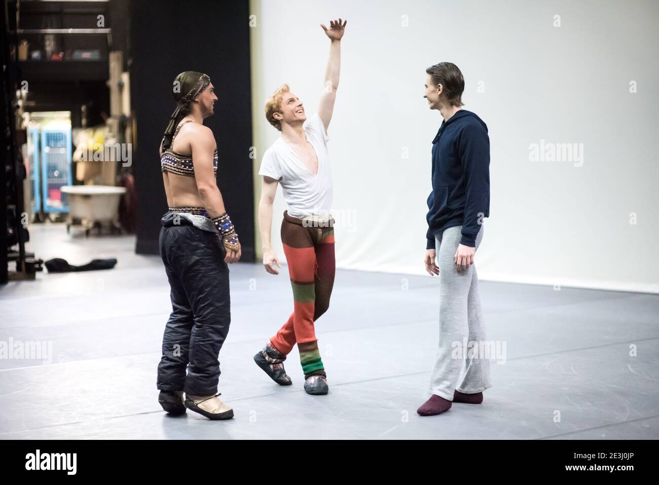 Three male ballet stars Ivan Vasiliev, Steven McRae and Vadim Muntagirov discuss ballet on stage before a gala performance Stock Photo