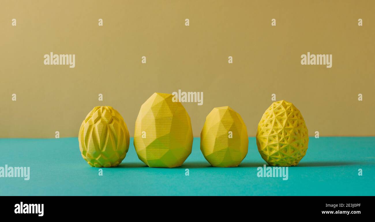 Four yellow Easter eggs with geometric patterns on yellow and green background with blank space for text. Horizontal panoramic banner. Stock Photo