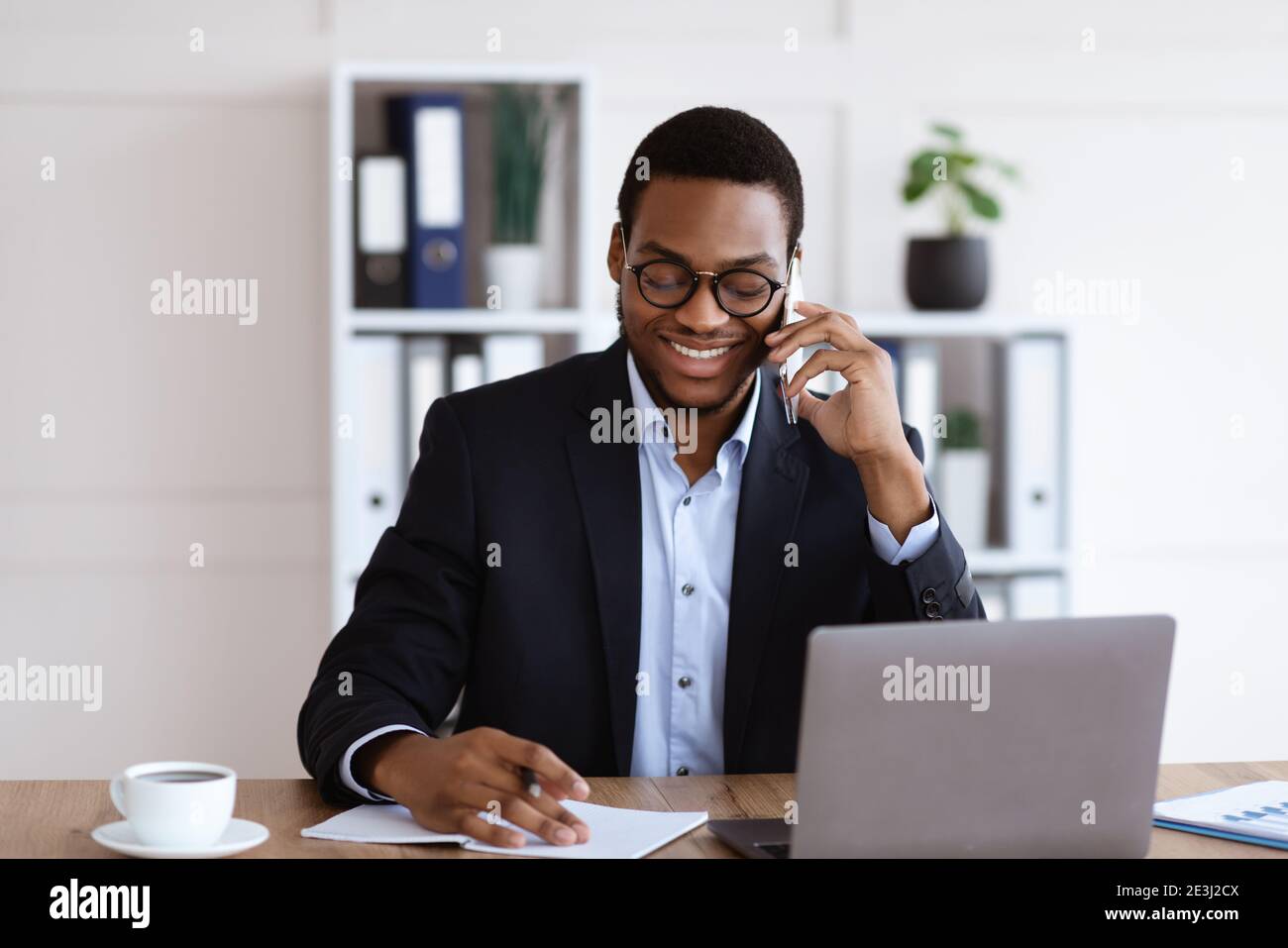 Positive Black Businessman Talking On Phone With Business Partners 