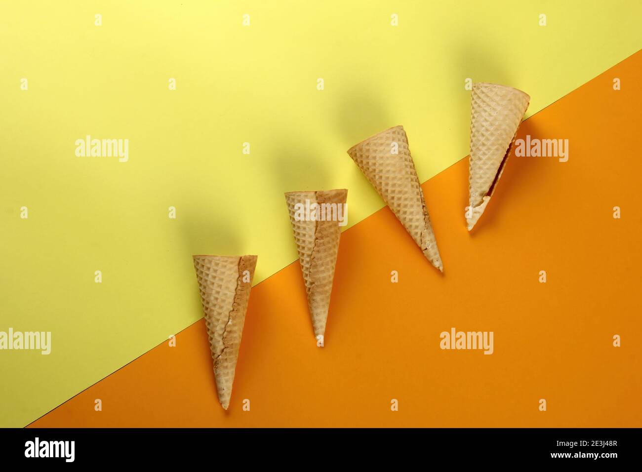 Emty Ice cream cones pattern on colored background. Top view. Several wafer ice cream cones designe Stock Photo