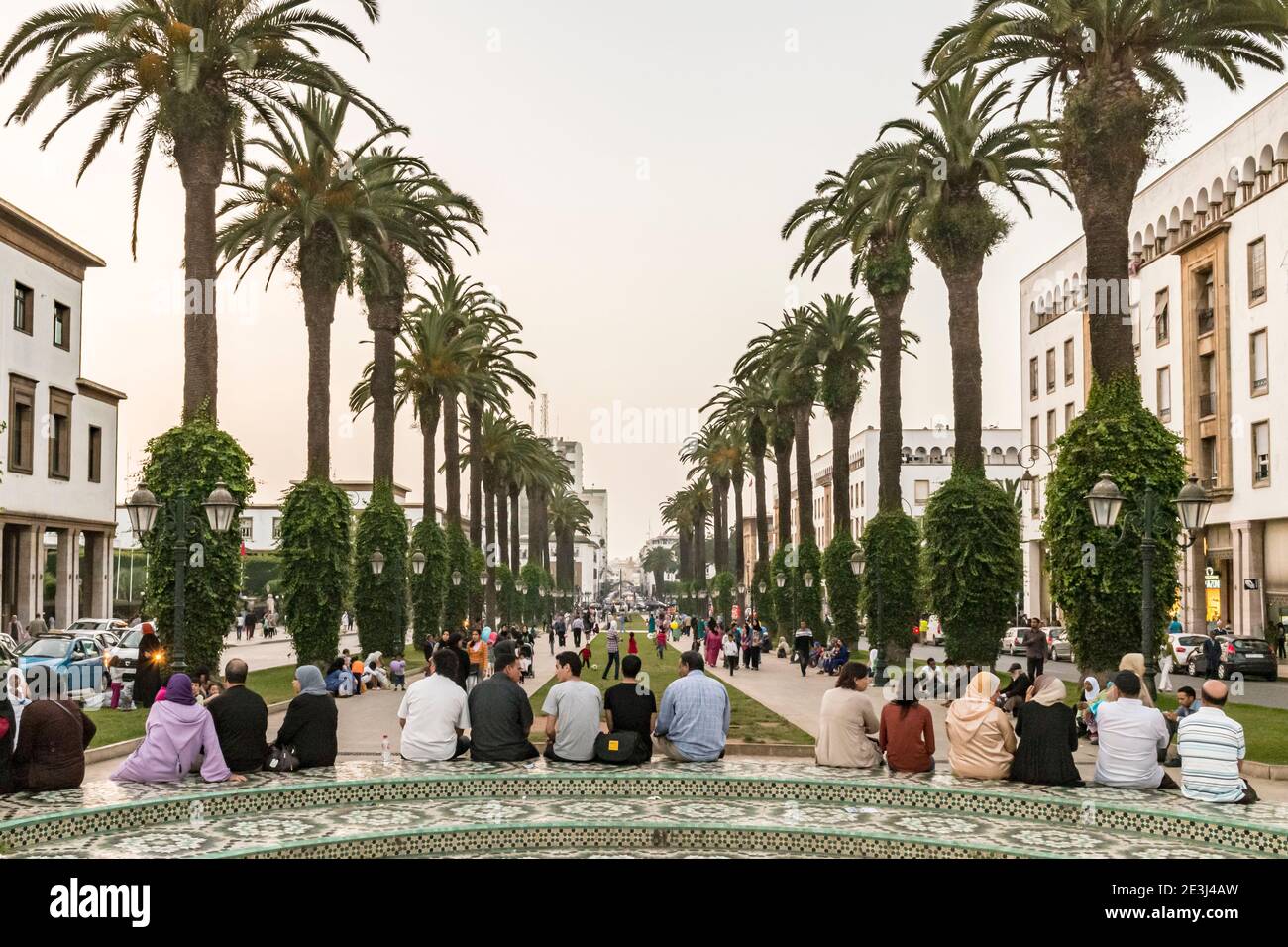 Locals gather to chat and socialise in a small park in Avenue Mohammed V in the Ville Nouvelle district of Rabat, Morocco. RABAT Early evening in the Stock Photo