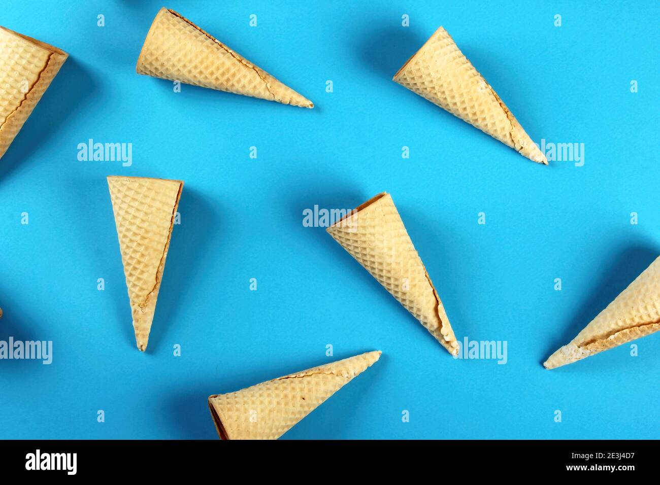 Emty Ice cream cones pattern on colored background. Top view. Several wafer ice cream cones designe Stock Photo