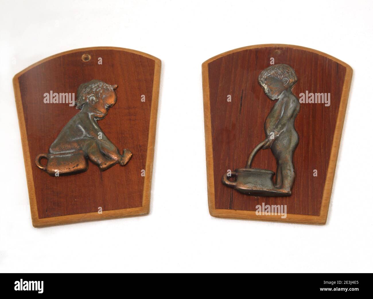 Vintage Mid Century Wood and Copper Boys and Girls Toilet Signs Stock Photo