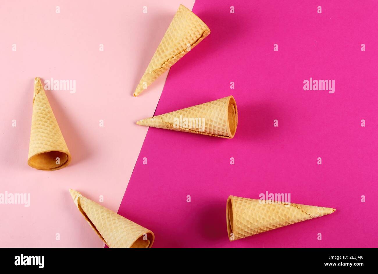 Emty Ice cream cones pattern on colored background. Top view. Several wafer ice cream cones designe Stock Photo