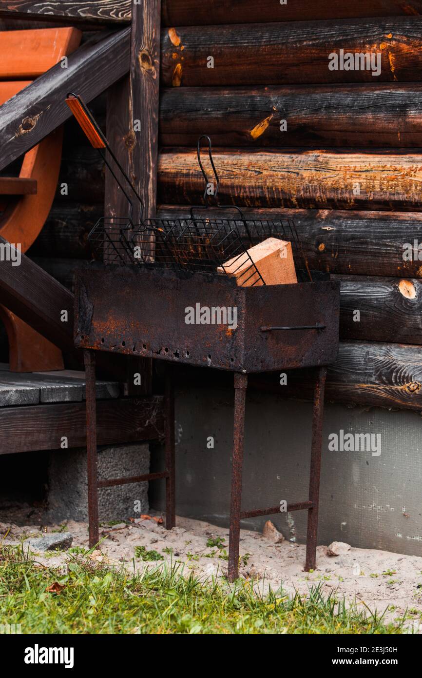 Barbecue rusty metal grill with wood Stock Photo Alamy