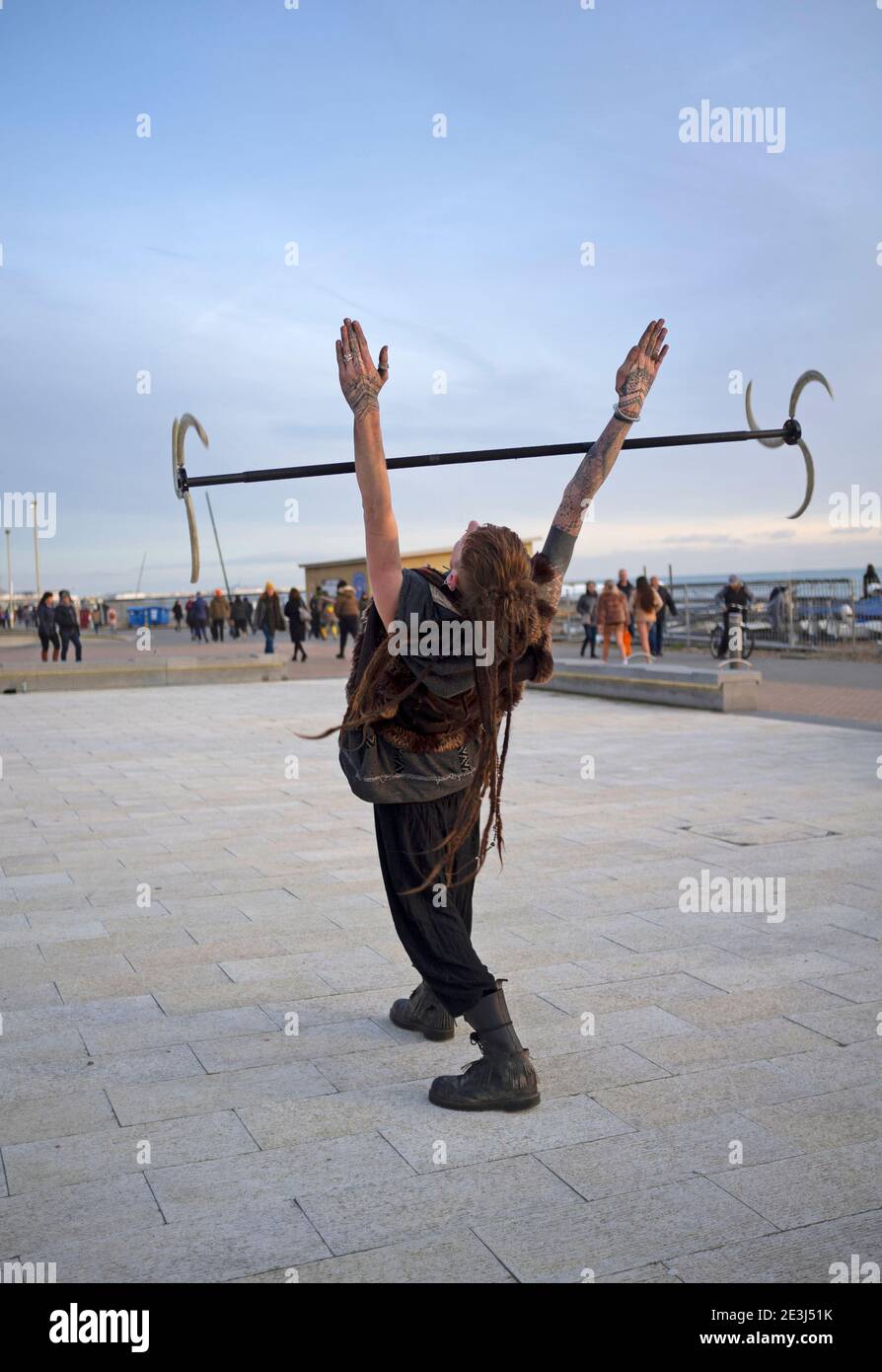In Brighton a man practises his skills in in twirling a bladed stick
