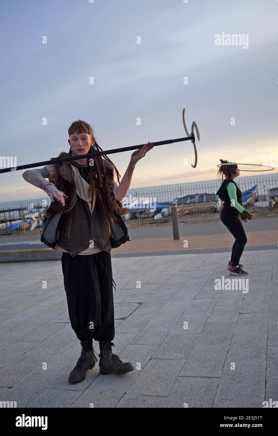 In Brighton a man practises his skills in in twirling a bladed stick