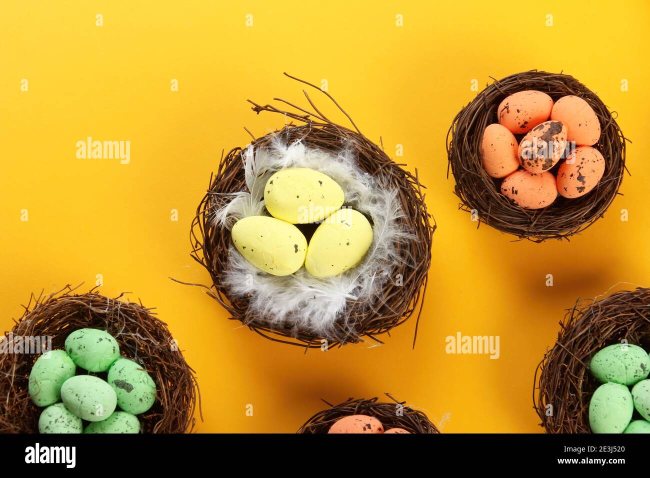 Bird nests with eggs on a colored background, Easter concept. Top view, selective focus, copy space Stock Photo