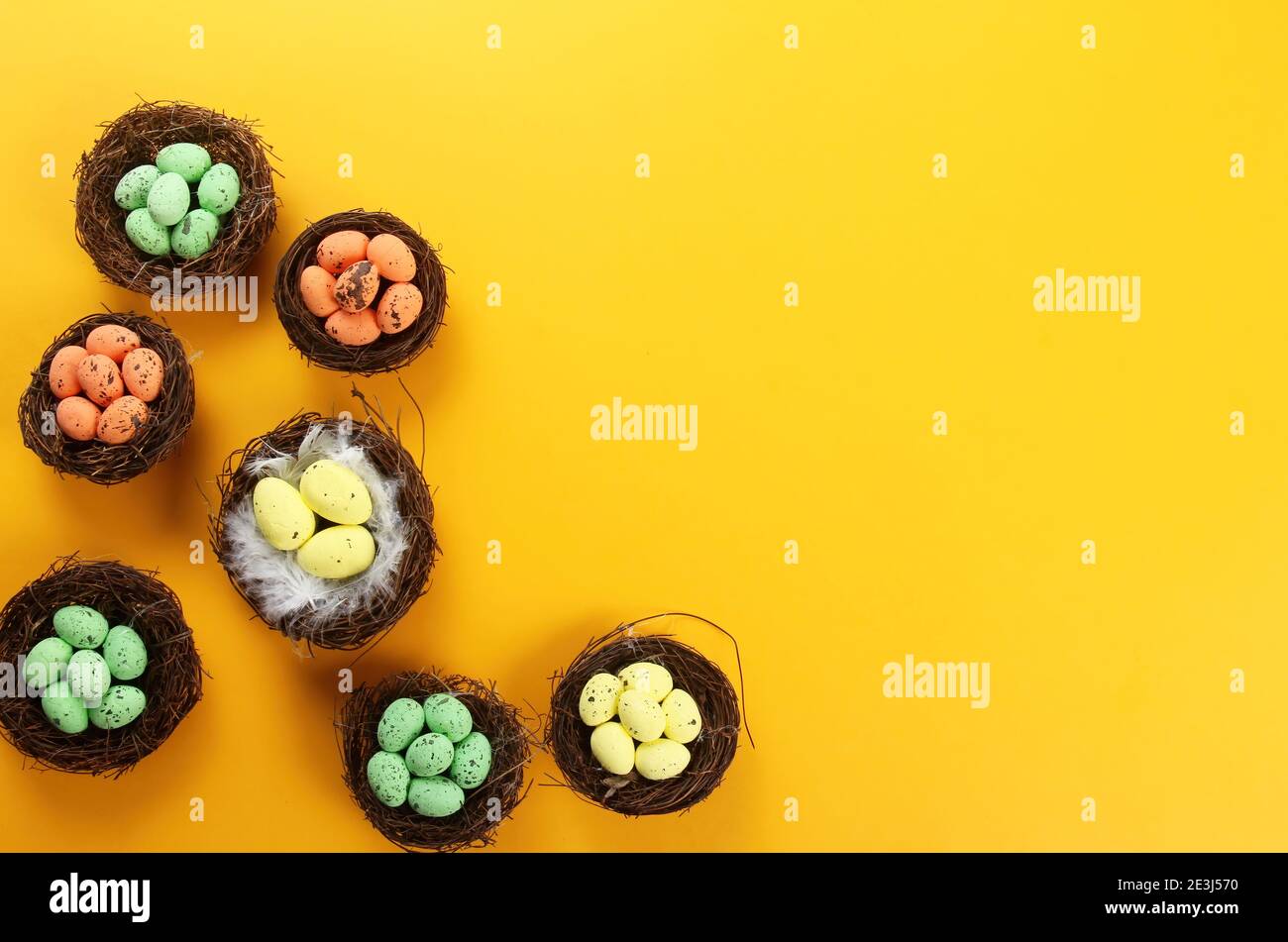 Bird nests with eggs on a colored background, Easter concept. Top view, selective focus, copy space Stock Photo