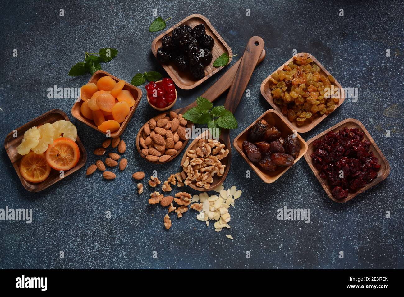 Mix of dried and sundried fruits, in a wooden trays . View from above