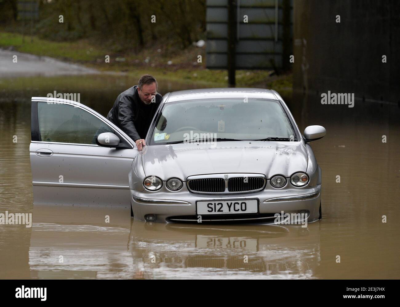 Leicester, Leicestershire, UK 19th Jan 2021. UK. Weather. Flooding. Kevin Dimbleby pushes his car out of floodwater underneath the A46 at Six Hills in Leicestershire after getting stuck. Kevin was on the way from his home in Lincoln to his dentists in Loughborough when he misjudged the depth of the water. Alex Hannam/Alamy Live News Stock Photo