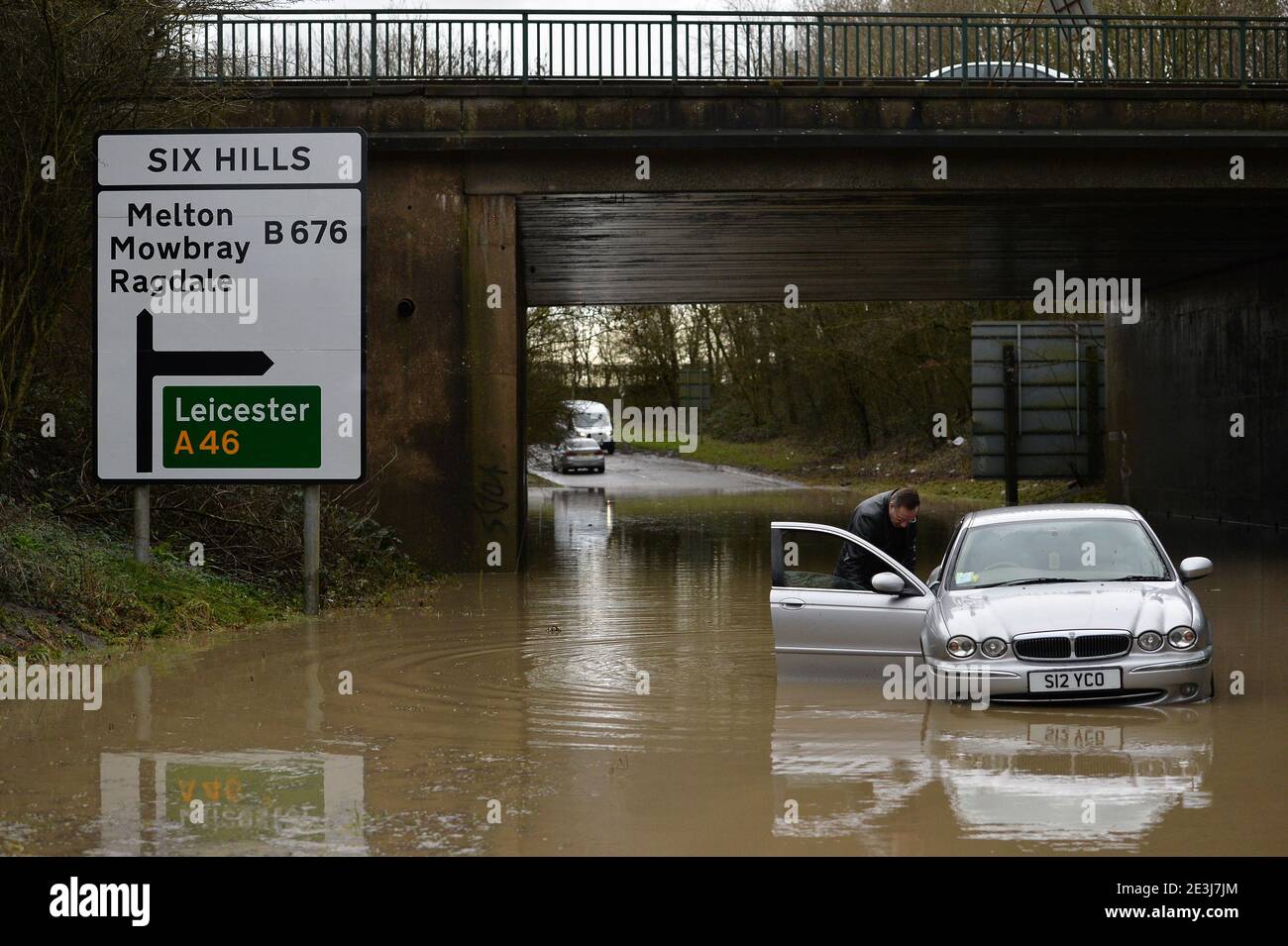 Leicester, Leicestershire, UK 19th Jan 2021. UK. Weather. Flooding. Kevin Dimbleby pushes his car out of floodwater underneath the A46 at Six Hills in Leicestershire after getting stuck. Kevin was on the way from his home in Lincoln to his dentists in Loughborough when he misjudged the depth of the water. Alex Hannam/Alamy Live News Stock Photo