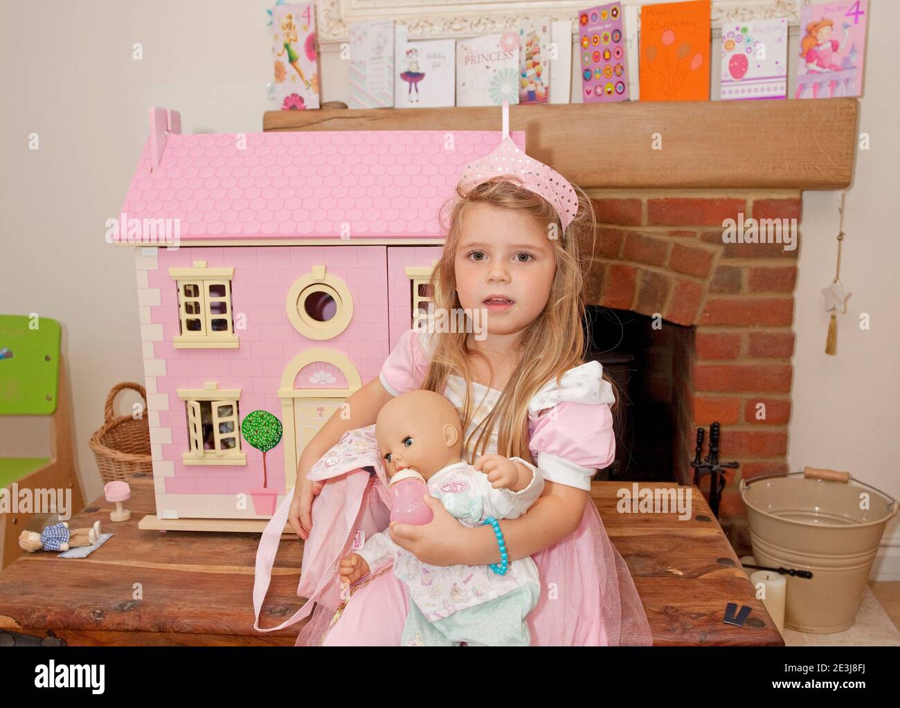 Young girl sat with her birthday presents Stock Photo