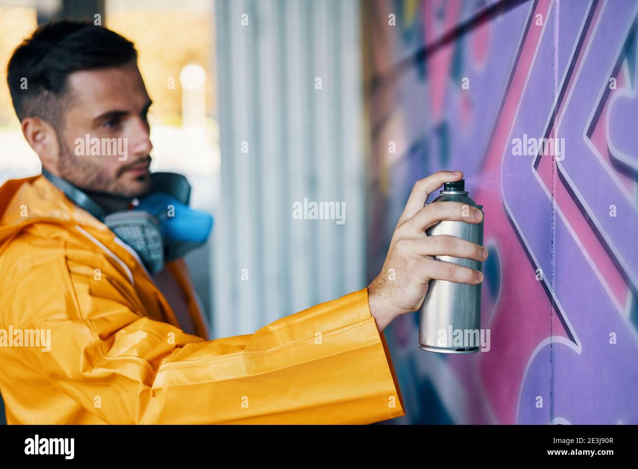 Street artist painting colorful graffiti on wall Modern art, urban ...