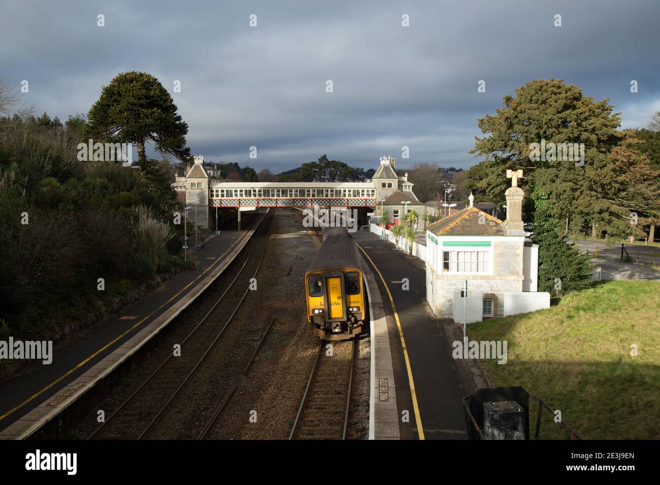 Torquay Rail Station with departing Train against a leaden sky Stock Photo
