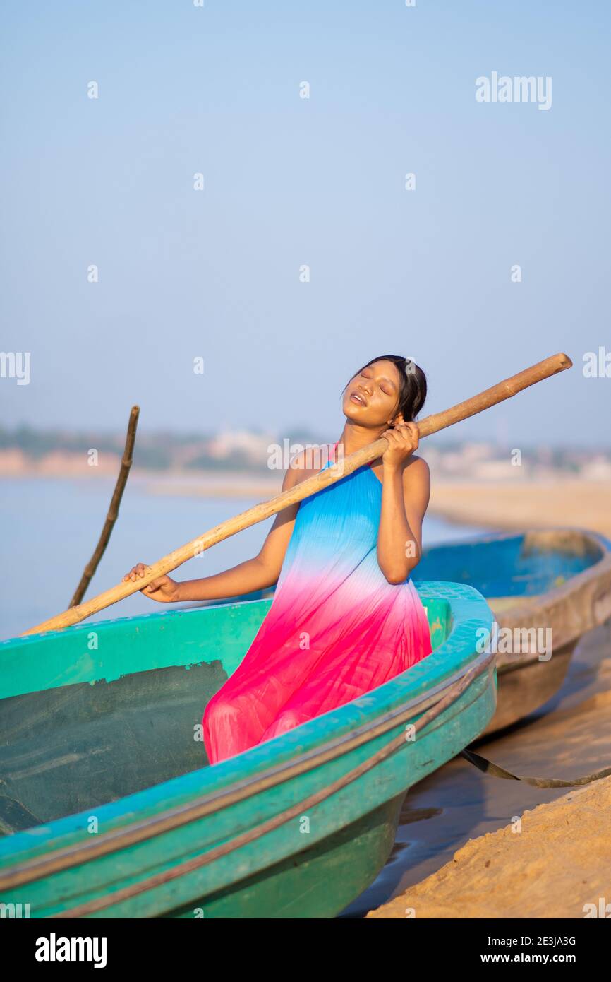 portrait of a beautiful young african woman posing on a local boat on ...