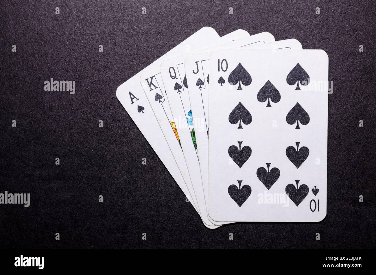 Playing cards on dark, black background, poker game hand, royal flush,  gambling concept, flat lay, view from directly above, top view Stock Photo  - Alamy